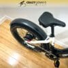 A white Denago Fat Tire Step-Thru with a black seat and tires is pictured on a wooden floor. Above the bike, there is a logo that says "Crazy Lenny's Electric Bikes" accompanied by a graphic of a cyclist. The Denago Fat Tire Step-Thru bike is seen from an angled top-down view. A white Denago Fat Tire Step-Thru with a black seat and tires is pictured on a wooden floor. Above the bike, there is a logo that says "Crazy Lenny's Electric Bikes" accompanied by a graphic of a cyclist. The Denago Fat Tire Step-Thru bike is seen from an angled top-down view.