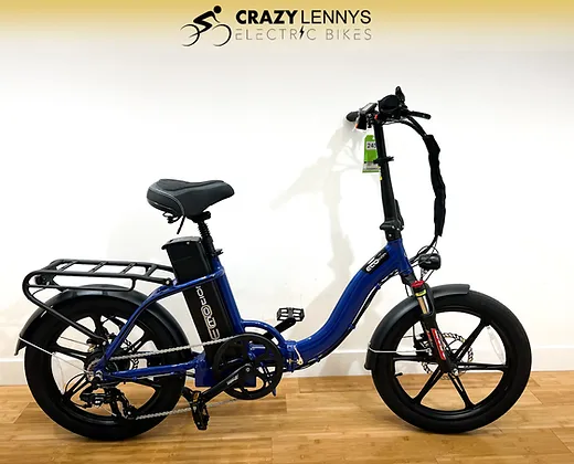 A blue EcoMotion Roko with a sturdy frame, black tires, and a rear cargo rack is displayed against a plain white background. The bike has a visible battery mounted behind the seat. The wall above the bike features the logo “Crazy Lenny's Electric Bikes.”