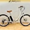 A white Serfas eDART 2023 350W electric bike with a brown saddle and handlebars stands against a white wall with a wooden floor. The logo "Crazy Lenny's Electric Bikes" is visible at the top. Featuring a 350W rear hub motor and 2023 disc brakes on both wheels, it promises an exhilarating ride. A white Serfas eDART 2023 350W electric bike with a brown saddle and handlebars stands against a white wall with a wooden floor. The logo "Crazy Lenny's Electric Bikes" is visible at the top. Featuring a 350W rear hub motor and 2023 disc brakes on both wheels, it promises an exhilarating ride.