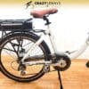 Image of a white electric bicycle with a brown saddle, featuring the logo "Crazy Lenny’s Electric Bikes" at the top. The EG Athens 350DX Hub Drive bike boasts a rear-mounted battery pack, hub drive, a chain guard, and a rear carrier rack. The background is a wooden floor and a cream wall. Image of a white electric bicycle with a brown saddle, featuring the logo "Crazy Lenny’s Electric Bikes" at the top. The EG Athens 350DX Hub Drive bike boasts a rear-mounted battery pack, hub drive, a chain guard, and a rear carrier rack. The background is a wooden floor and a cream wall.