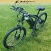 An electric bike with a black frame is positioned on a grassy field. The bike, possibly an EG Kyoto (Demo) model, features thick tires and a comfortable saddle. The logo "Crazy Lenny's Electric Bikes" is visible at the top of the image during this demo display. An electric bike with a black frame is positioned on a grassy field. The bike, possibly an EG Kyoto (Demo) model, features thick tires and a comfortable saddle. The logo "Crazy Lenny's Electric Bikes" is visible at the top of the image during this demo display.