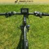 A top-down view of an EG Kyoto (Demo) electric bike's handlebars on a grassy lawn. The bike's display screen shows 0.0 miles per hour, and various control buttons are present on the handlebars. The branding "Crazy Lennys Electric Bikes" is visible at the top, offering a sleek demo for potential riders. A top-down view of an EG Kyoto (Demo) electric bike's handlebars on a grassy lawn. The bike's display screen shows 0.0 miles per hour, and various control buttons are present on the handlebars. The branding "Crazy Lennys Electric Bikes" is visible at the top, offering a sleek demo for potential riders.