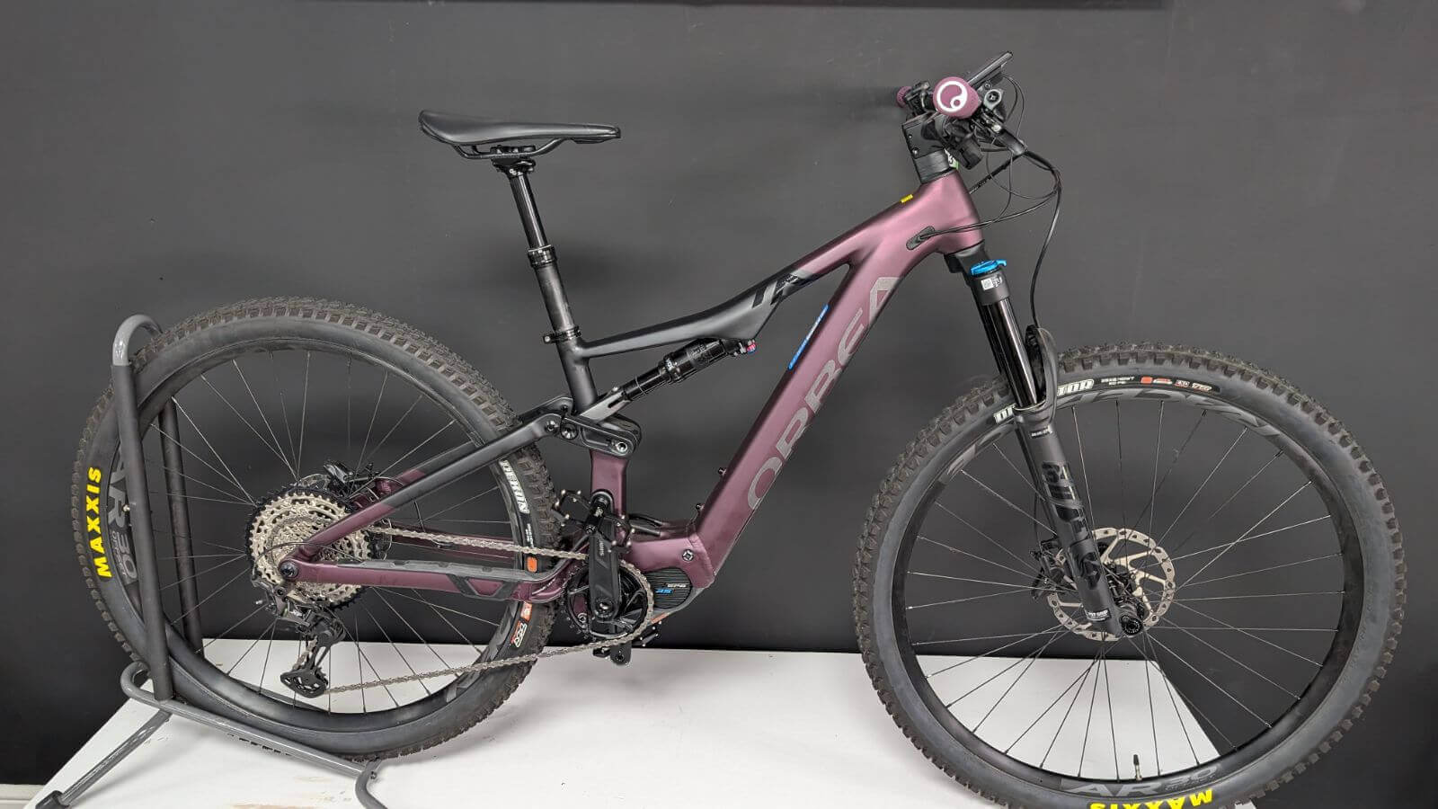 Purple mountain bike on a black background.