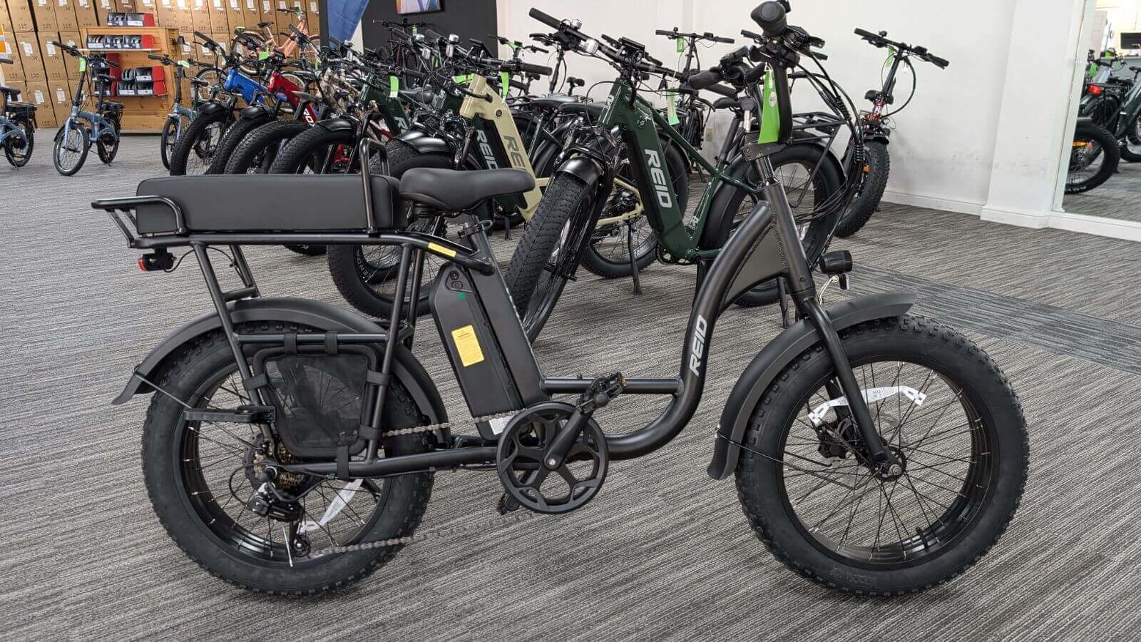 Electric bike showroom with various models on display.