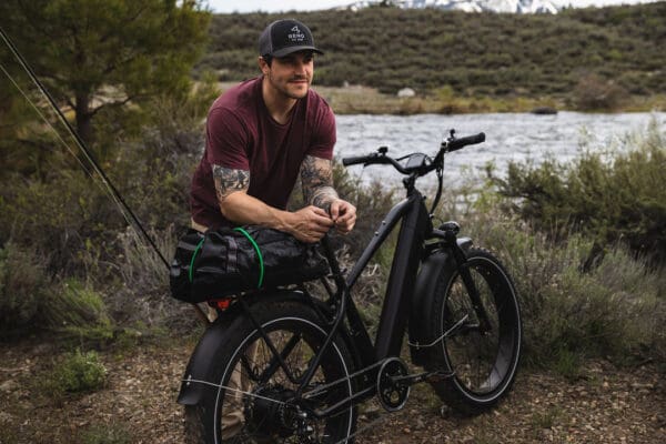 Man with bicycle near river outdoors