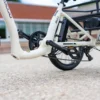 EMOJO_Bull_Pompermayer_7522 Close-up of white cargo bicycle frame and pedals.