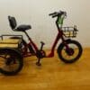 Emojo-Bull-1024x768 Red three-wheeled cargo bike on wood floor.
