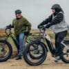 denago-fat-tire-and-hunting-ebikes_0cc84085-4567-4ed9-b731-262f08b86e14_1800x Two people riding Denago e-bikes outdoors.