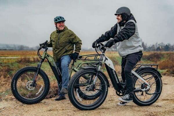 Two people riding Denago e-bikes outdoors.