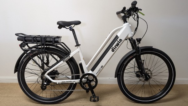 White electric bicycle with basket on rear.
