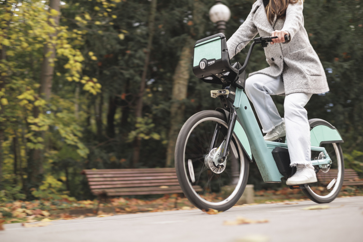 Woman riding electric bike in park