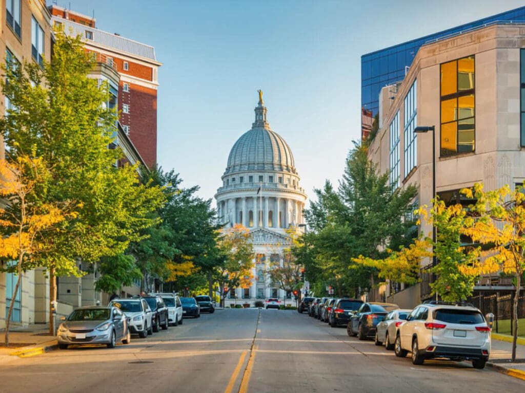 Street view towards government building and parked cars.
