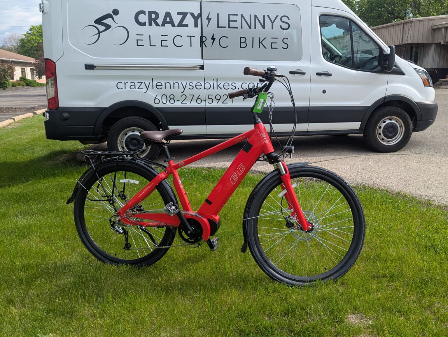 Red electric bike in front of company van.