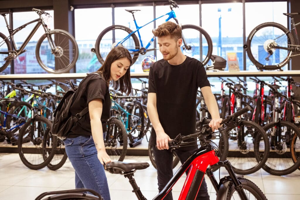 Two people browsing bikes in store.