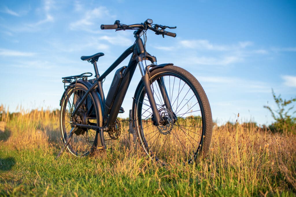 Electric bike on grassy field at sunset