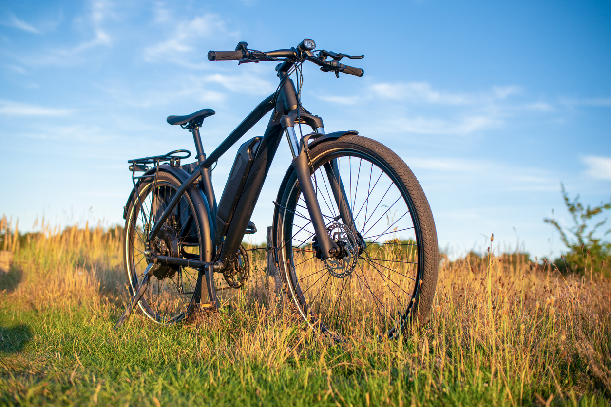 Electric bike on grassy field at sunset