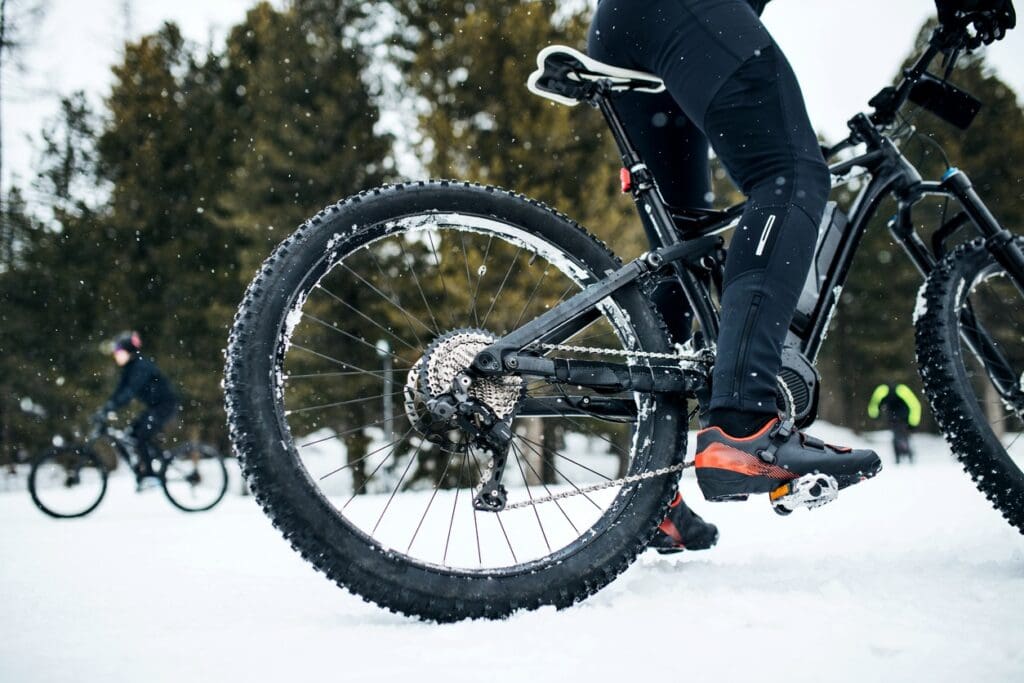 Cyclist riding mountain bike in snow