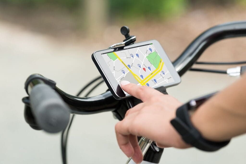 Cyclist using GPS navigation on smartphone.