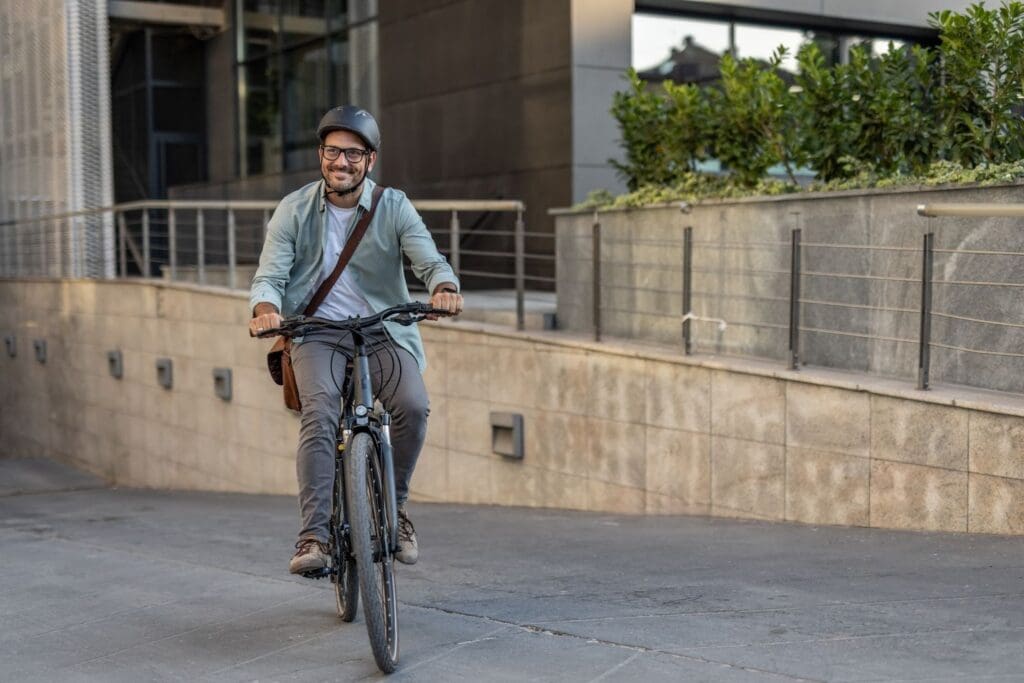 Person happily cycling through urban area.