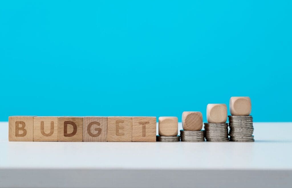 Budget planning with stacked coins and blocks.