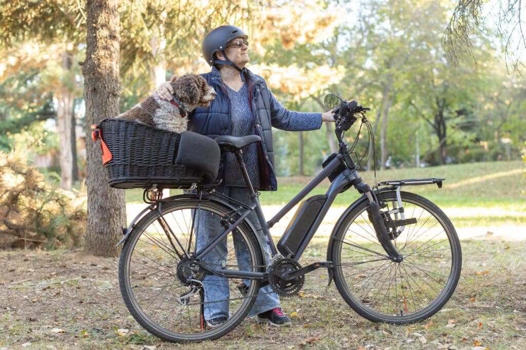 Person with dog on bike in park