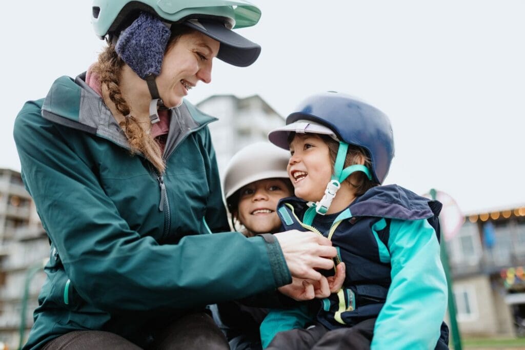 Smiling family in helmets outdoors