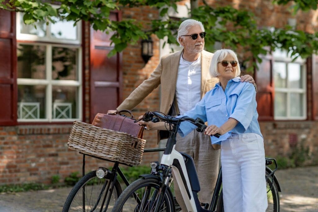 Elderly couple enjoying outdoor bike ride together.