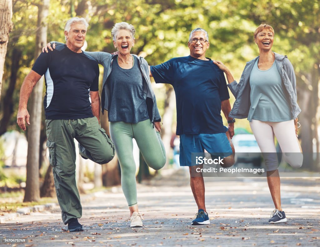 Group of seniors exercising outdoors together.