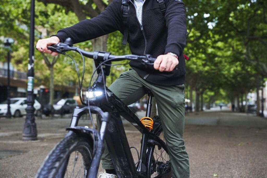 Person riding electric bike in city park