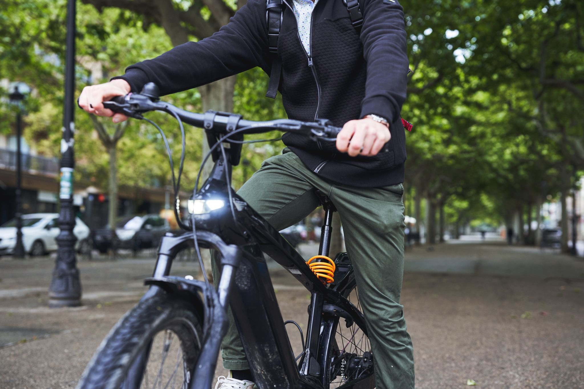 Person riding electric bike in city park