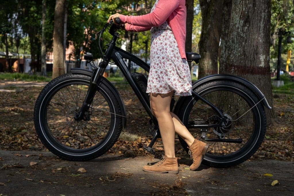 Woman standing with electric bike in park