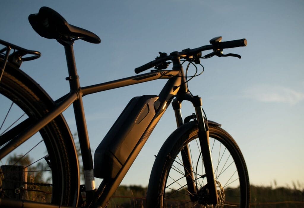 Modern electric bicycle at sunset outdoors