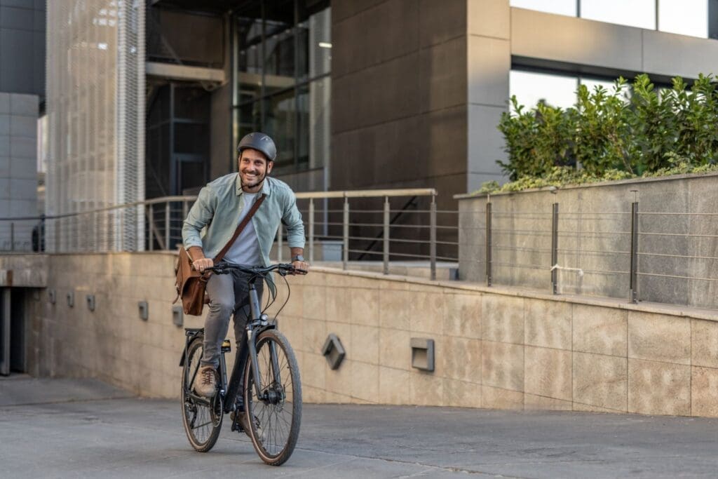 Smiling man cycling in modern urban setting