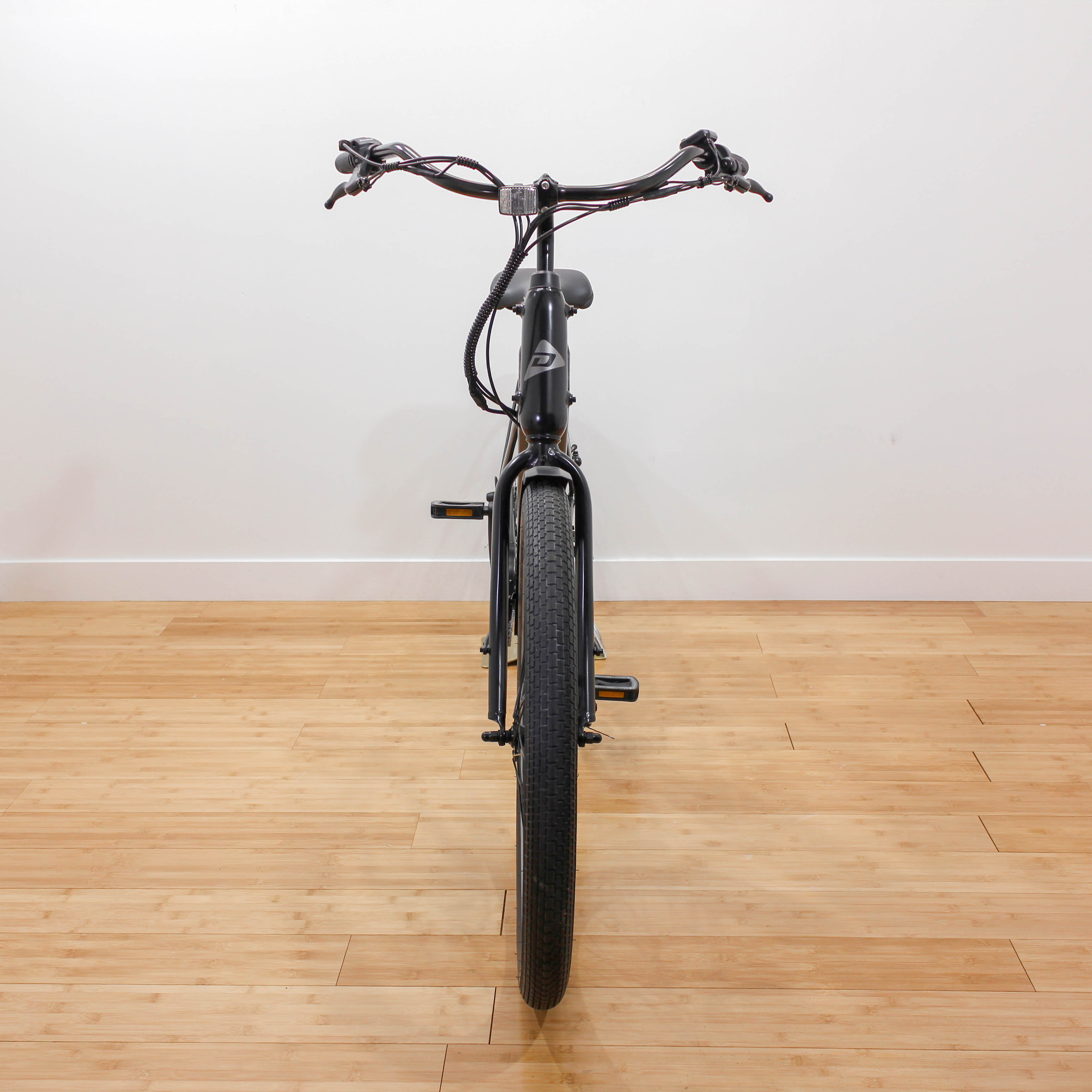 Front view of black bicycle indoors