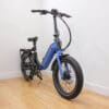 Denago - Folding 1 - Blue with Black - 2 Front Quarter Blue folding electric bicycle indoors on wooden floor
