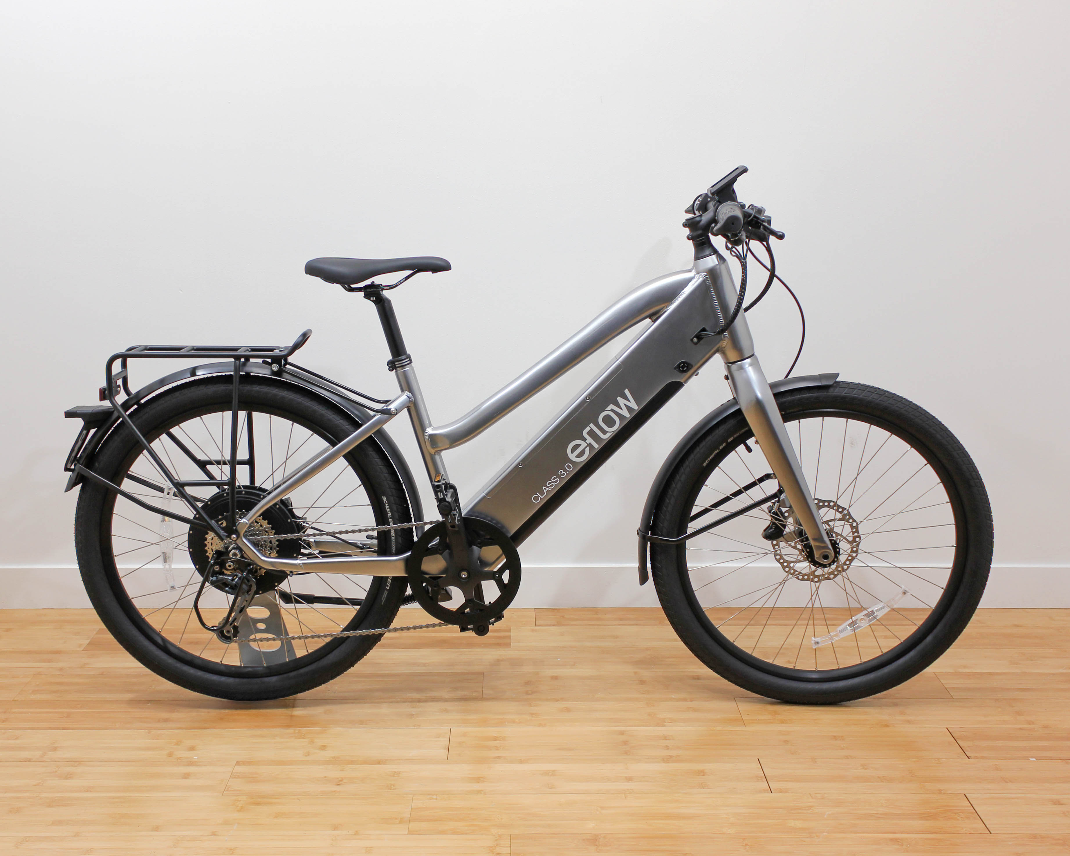Silver eFlow electric bike with rear rack indoors