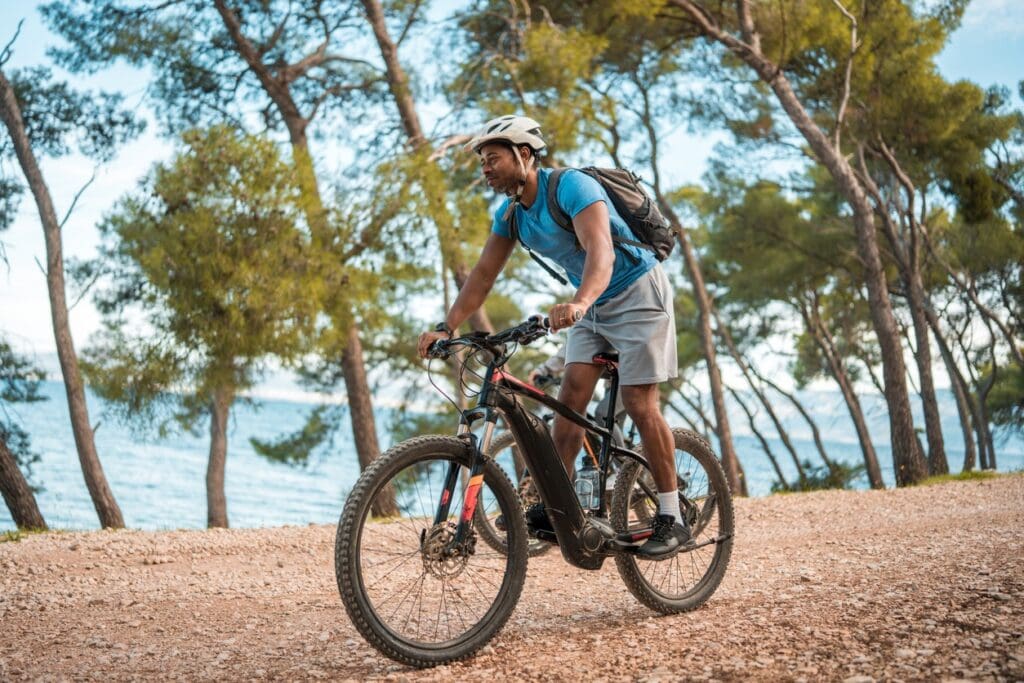 Man riding electric mountain bike on coastal trail