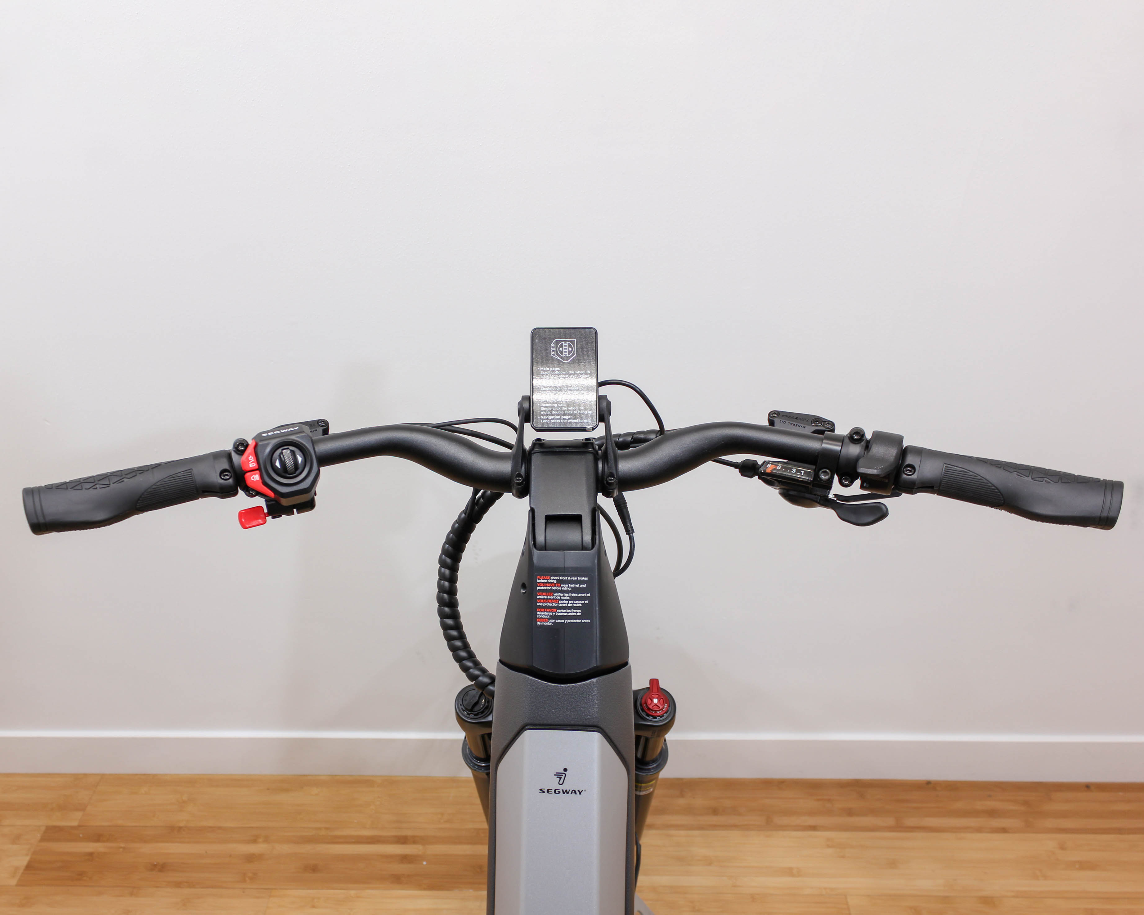 Segway electric bike handlebars against plain wall